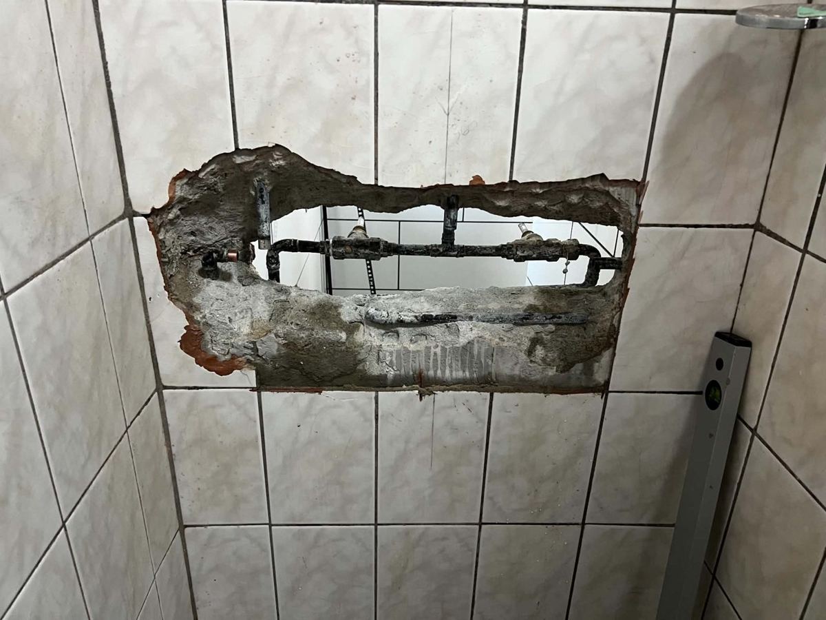 Wall opened up to the old shower pipework