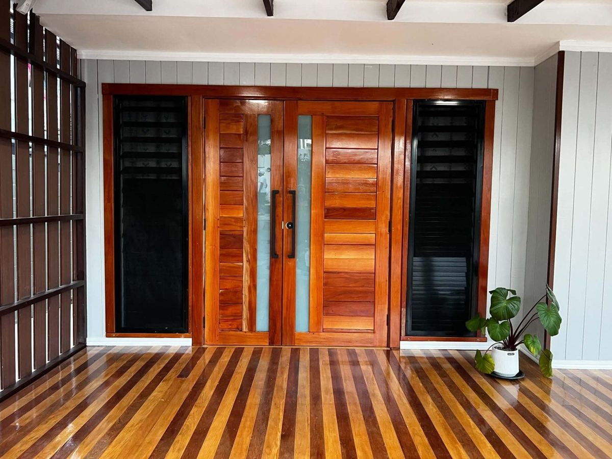 Completed entry — timber double doors with louvre side panels