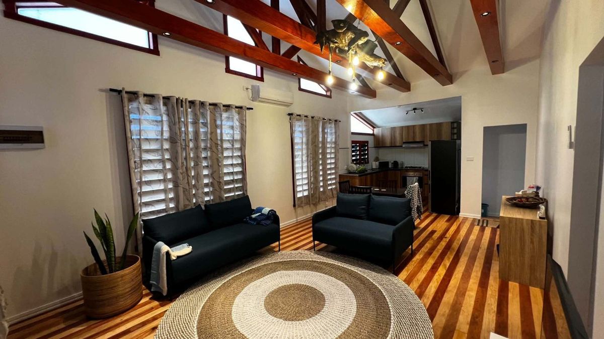 Completed living area — dressed rafters, clerestory windows, feature light and new timber floor
