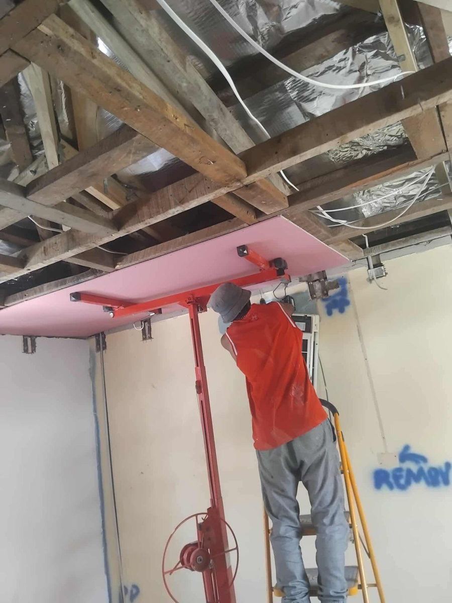 Lining the new plasterboard ceiling