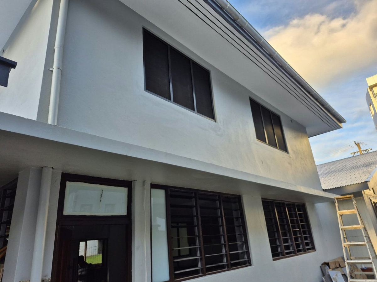 Completed exterior — repainted, with new windows and louvres