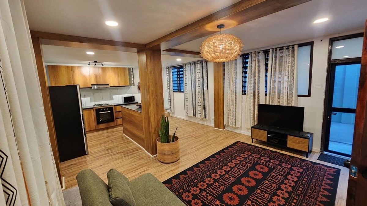 Completed open-plan living area with timber-clad beams and columns