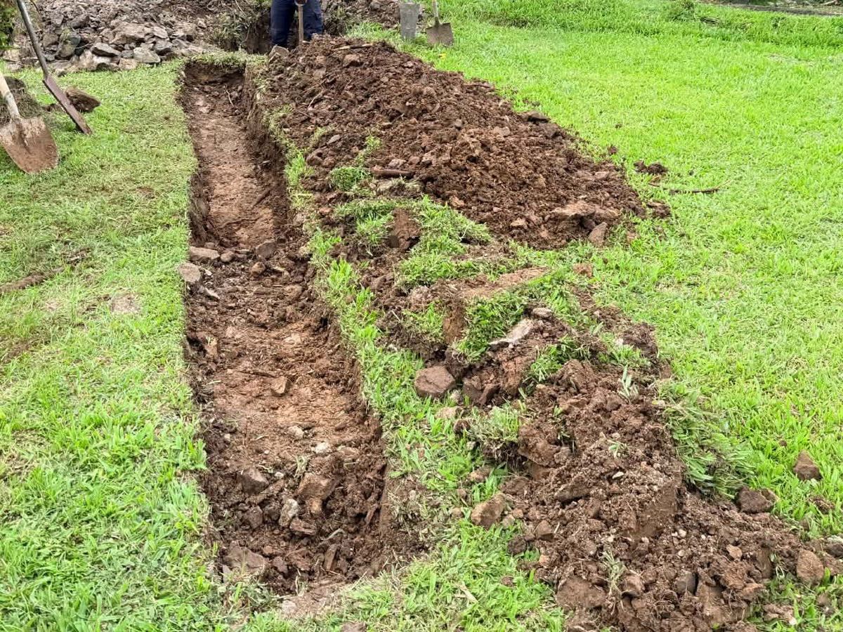 Soakage trench excavated across the lawn