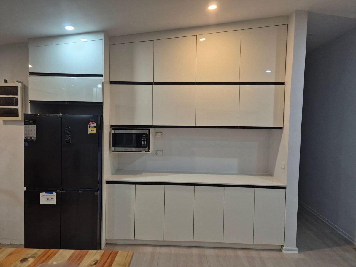 Completed storage wall with fridge and microwave housings